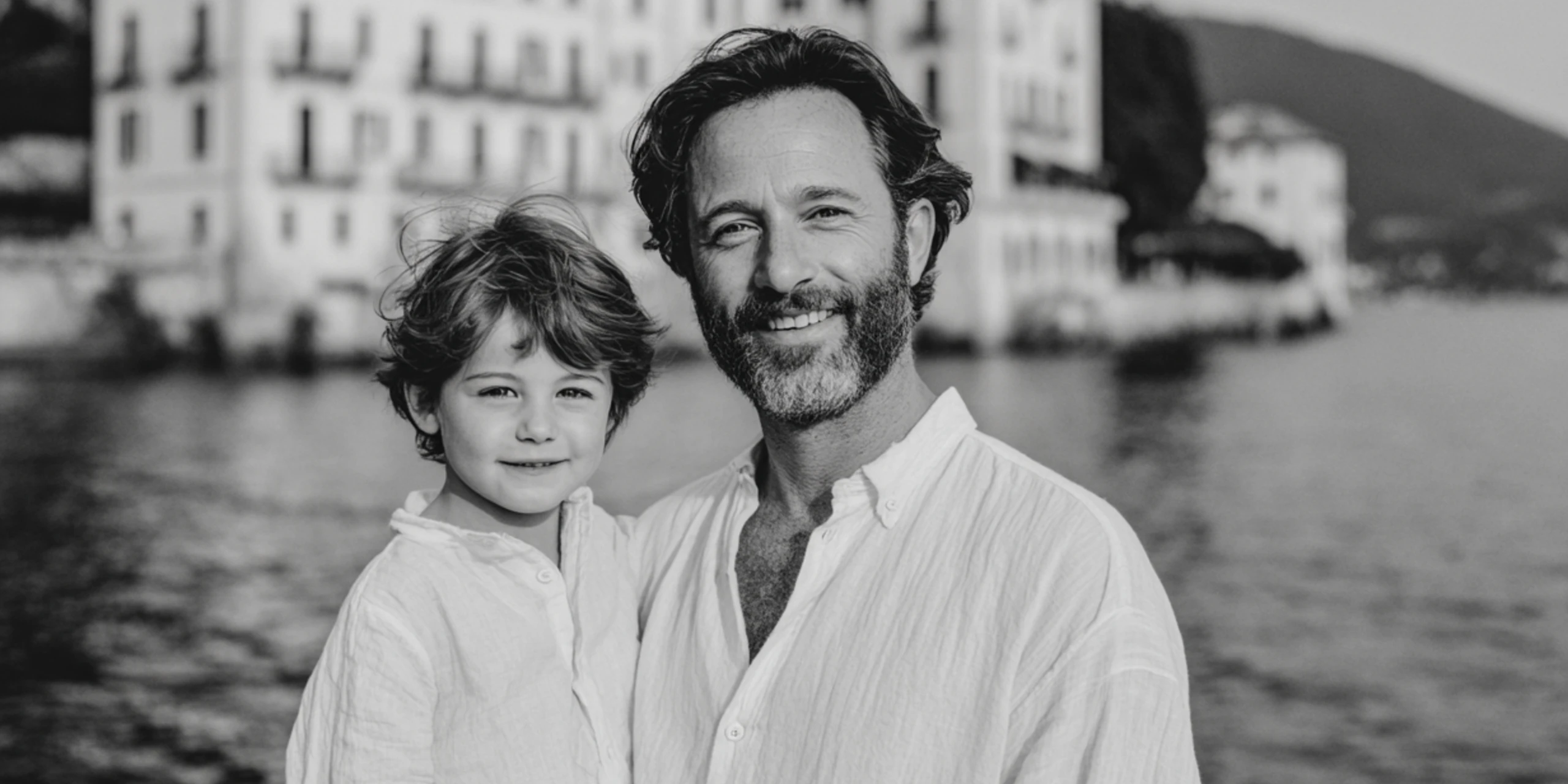 black and white photograph of father and son by shores of Lake Como