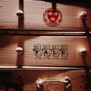 Harvard and yale trunks stacked on top of one another