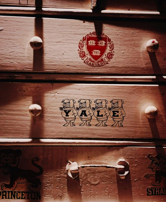 Harvard and yale trunks stacked on top of one another
