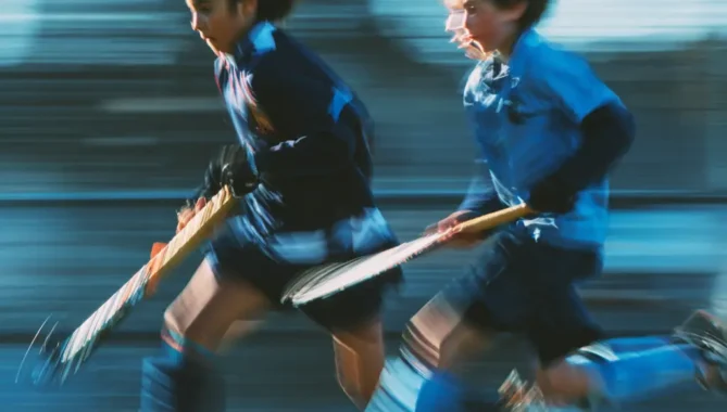 Close up blurry picture of two kids in motion playing hockey