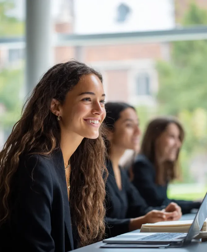 Female graduate students smiling in class