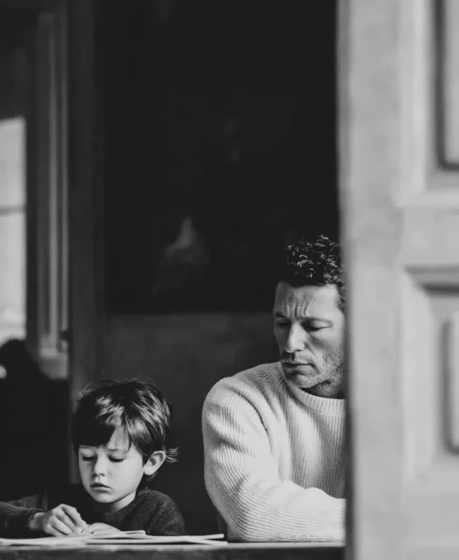 Father and son at desk studying
