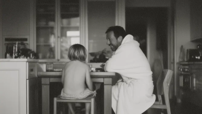 Black and white photo of father and son having breakfast in large American style house