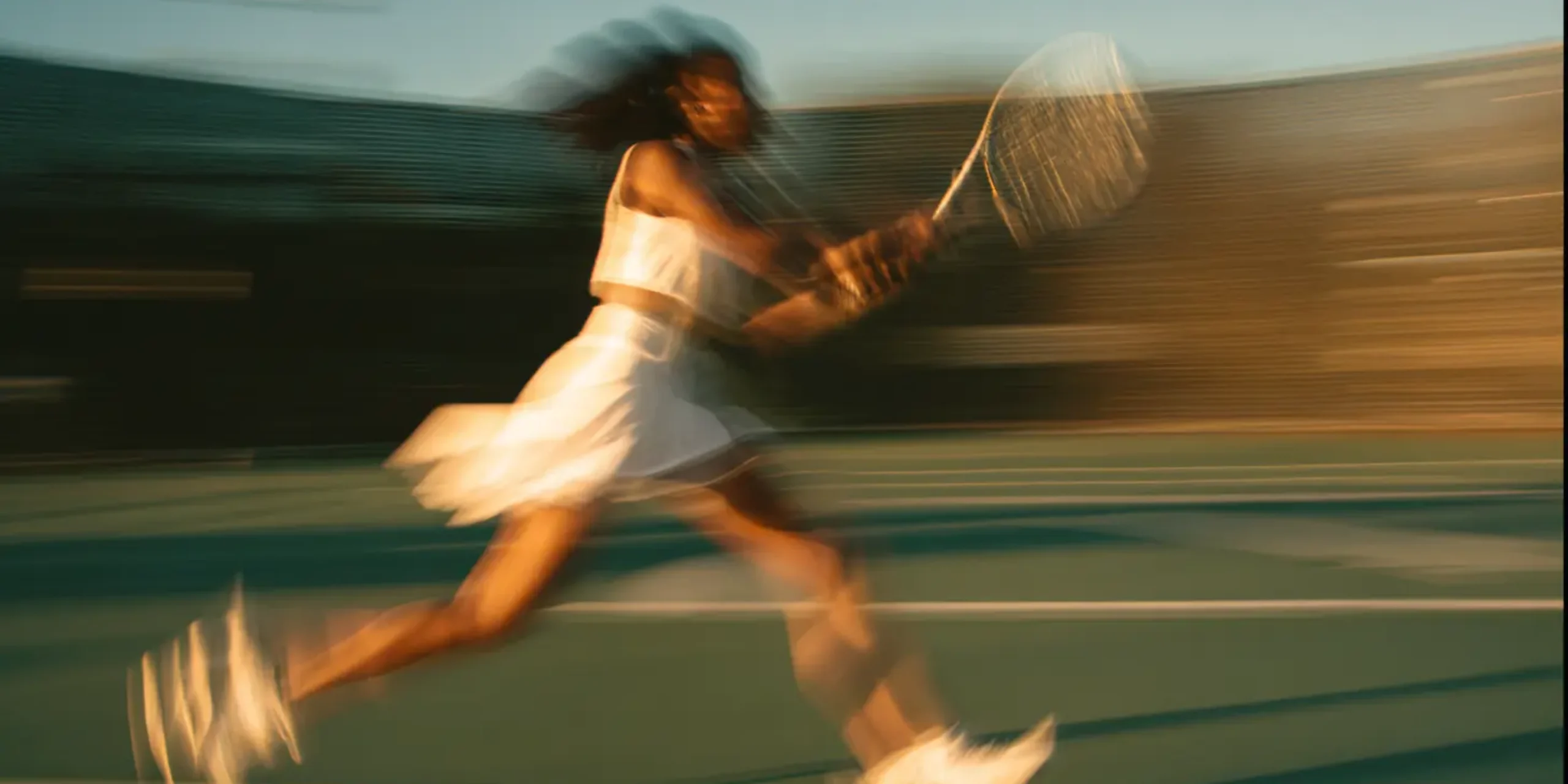 Female tennis player running across court