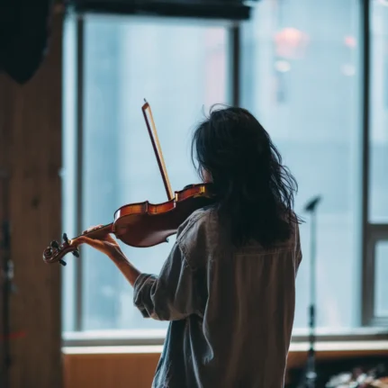 Photograph of female violinist from behind