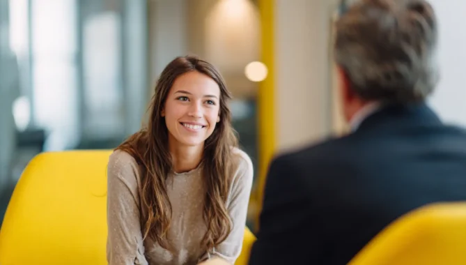 Happy teenage girl speaking to a consultant