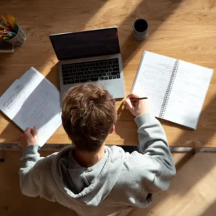 Photo top down angle of boy studying at desk at home