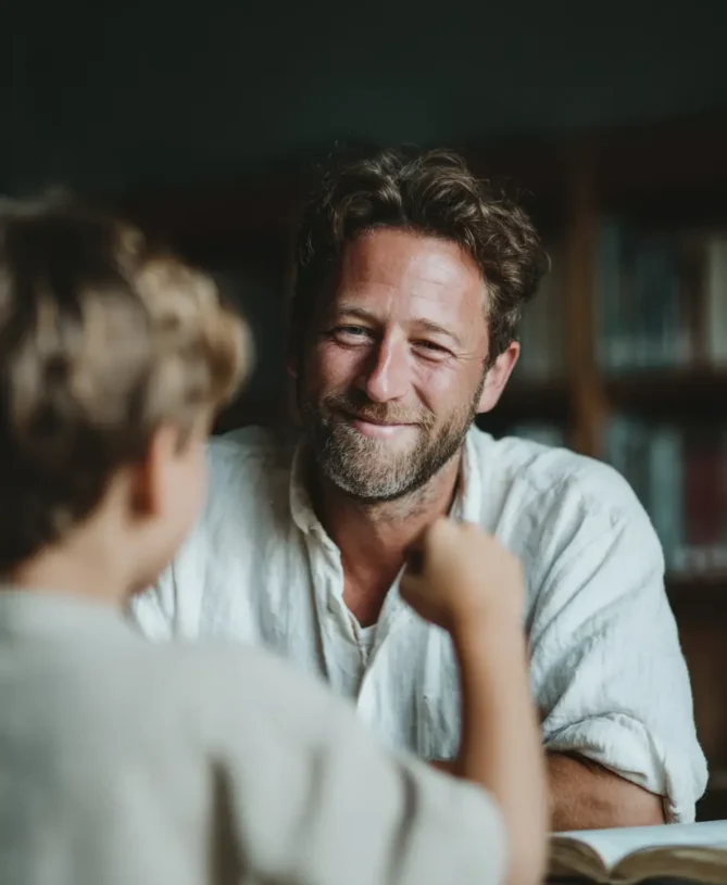 A smiling male tutor fist bumps a student