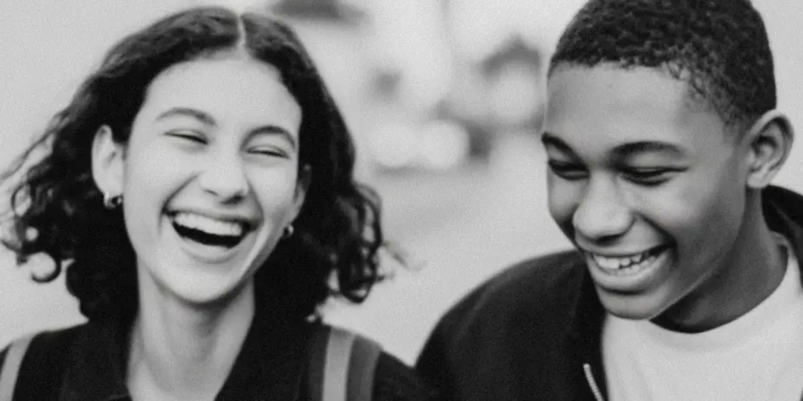 Teenagers smiling whilst walking down the street in Paris