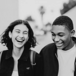 Teenagers smiling whilst walking down the street in Paris