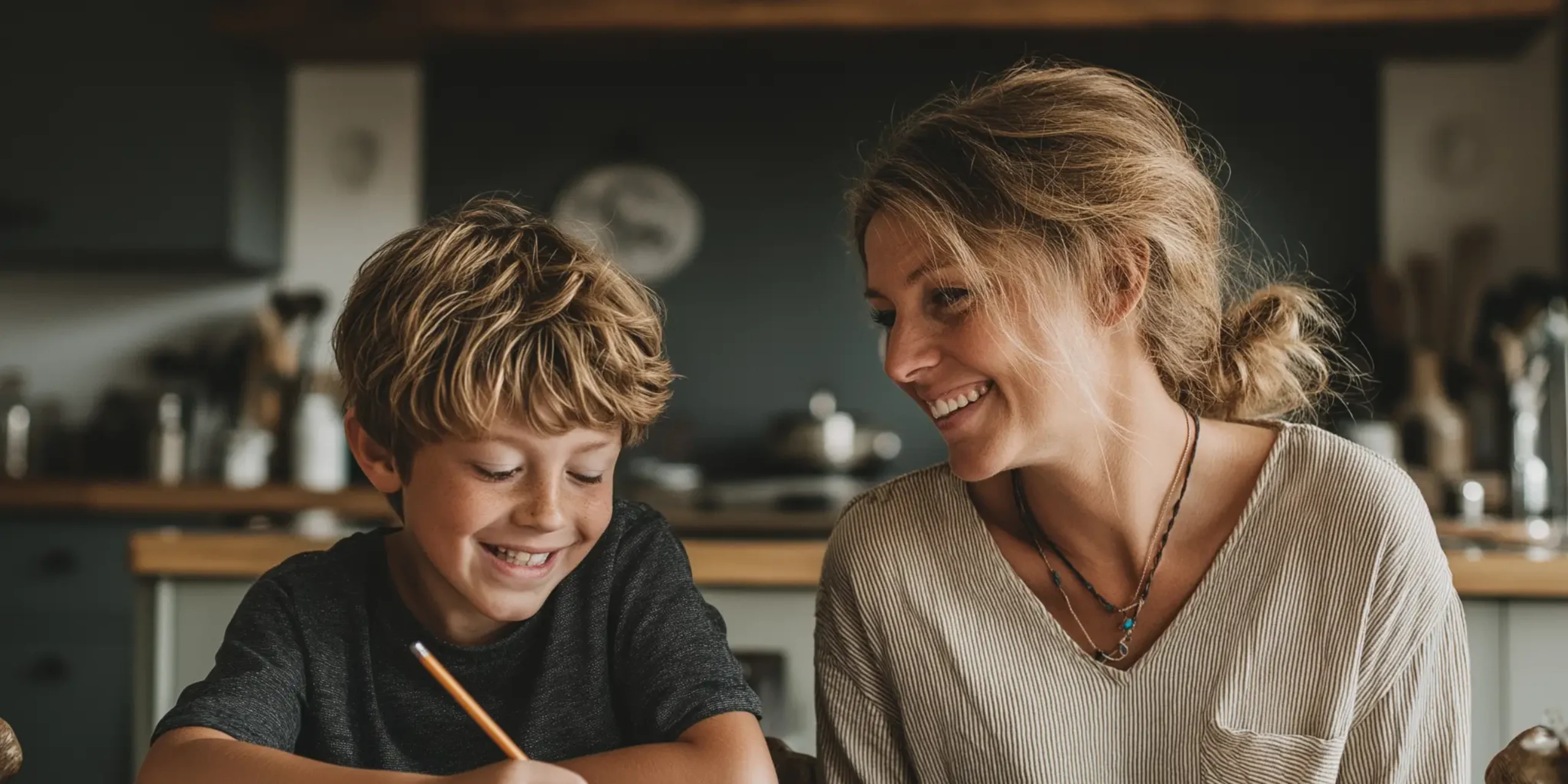 Smiling tutor and student sat at dining table at home for maths tuition