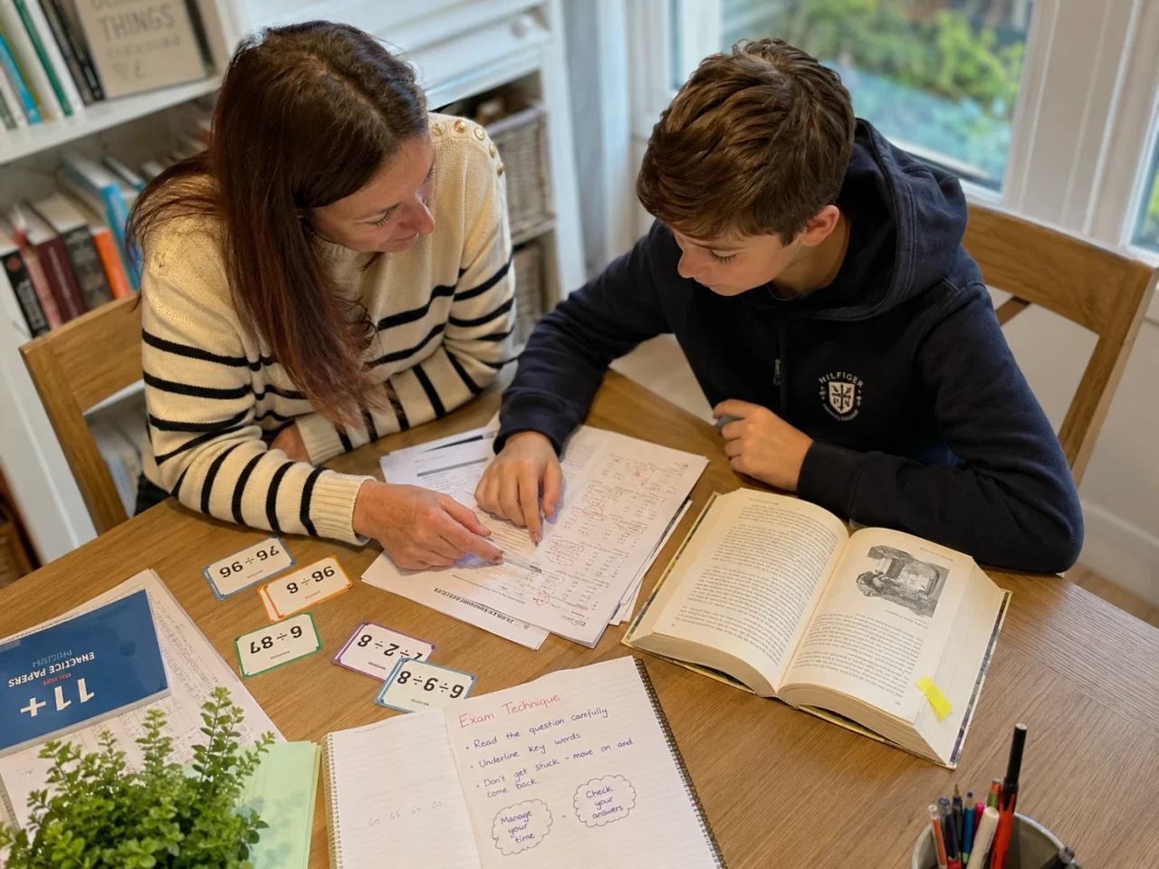Study hours for 11 Plus exam preparation with a tutor and child reviewing focused practice work.