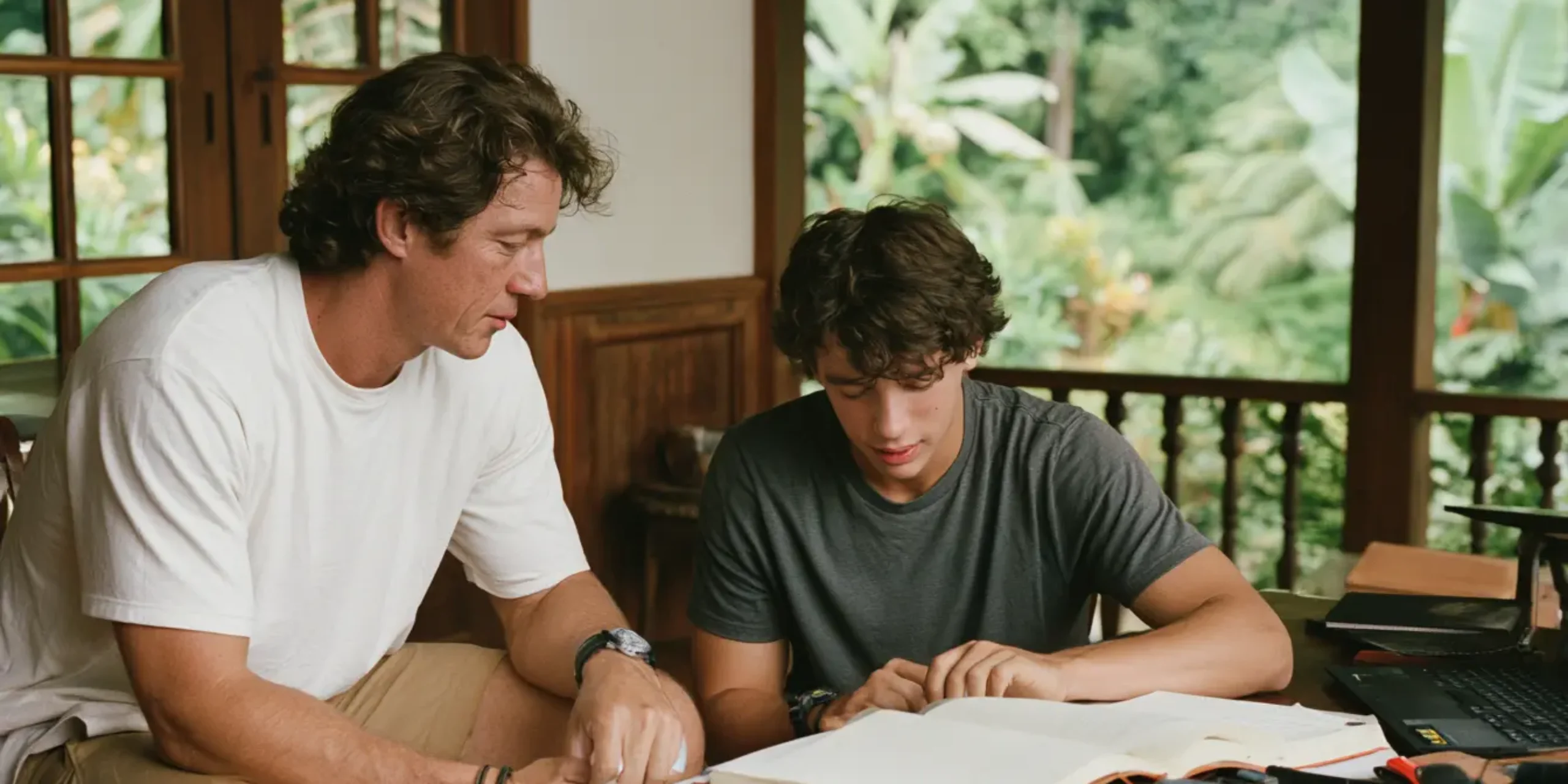Mentor and tutor teaches a teen at home in a beautiful home in the caribbean