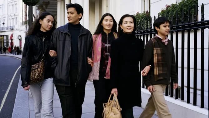 Asian family walks through London hand in hand